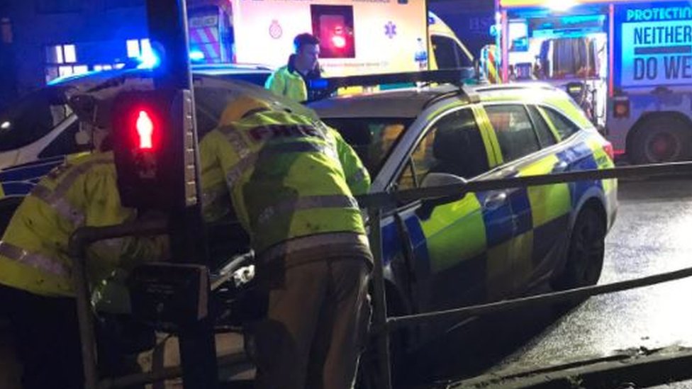 Officer treated for suspected neck injury after police car crash - BBC News