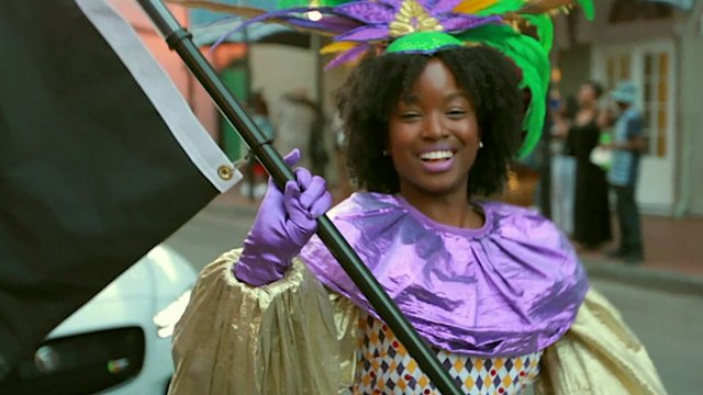 A young black woman dancing in a parade