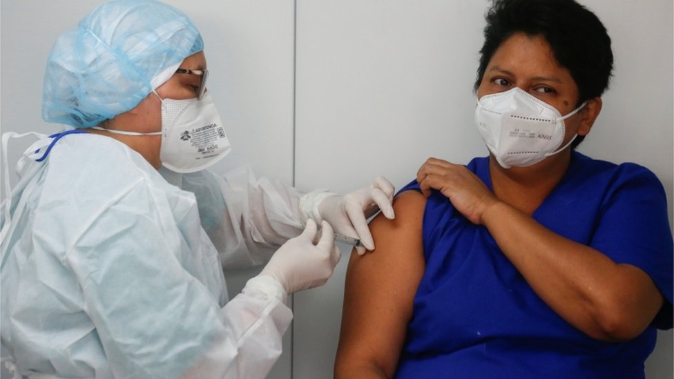 Mujer siendo vacunada en El Salvador