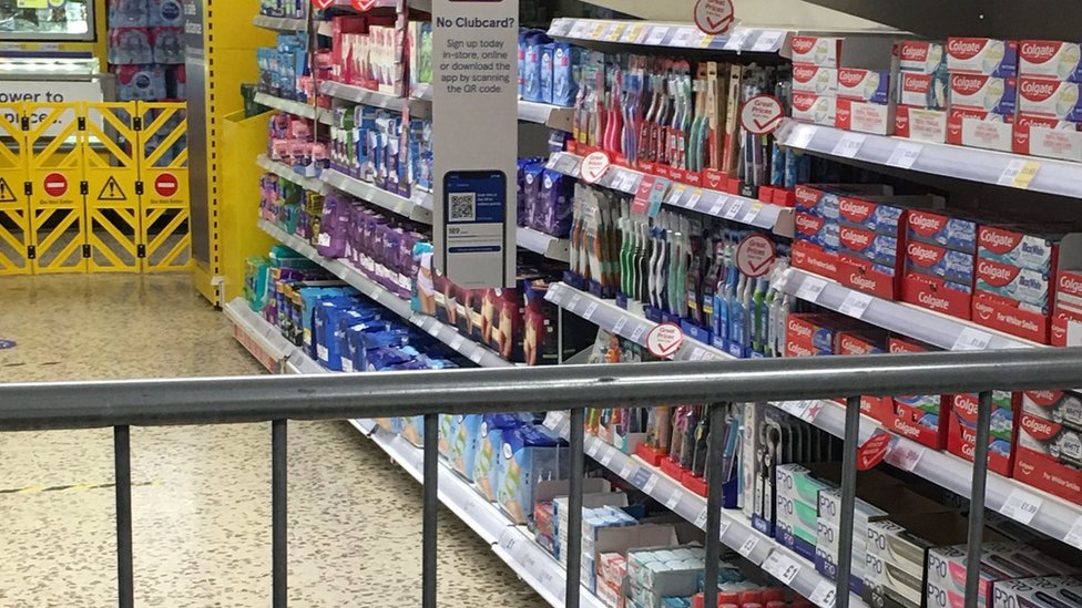 Railings cordoning off an area of Tesco containing sanitary products