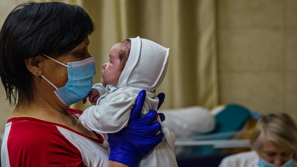 A nurse with a baby in Kyiv's underground nursery