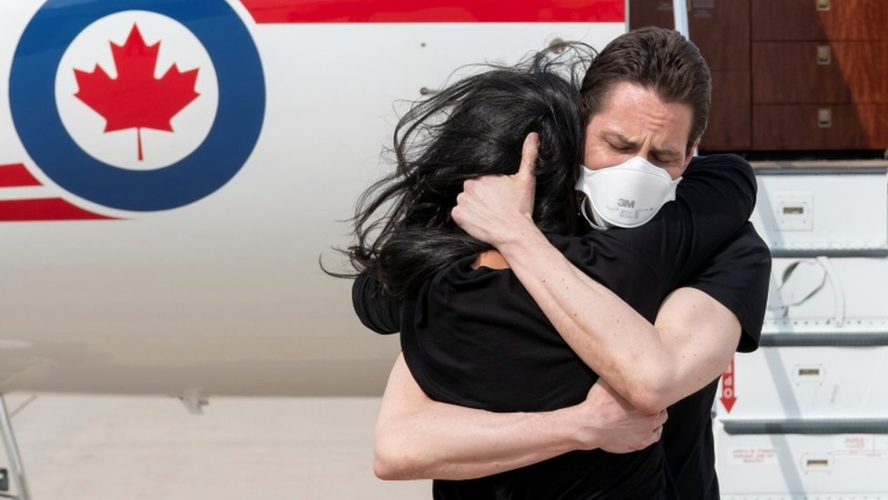 Former diplomat Michael Kovrig embraces his wife Vina Nadjibulla following his arrival in Toronto