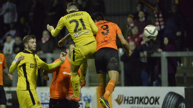 Cliftonville's Jay Donnelly heads in the equaliser against Carrick Rangers