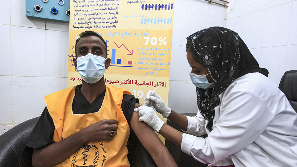 A man is vaccinated in Sudan against Covid