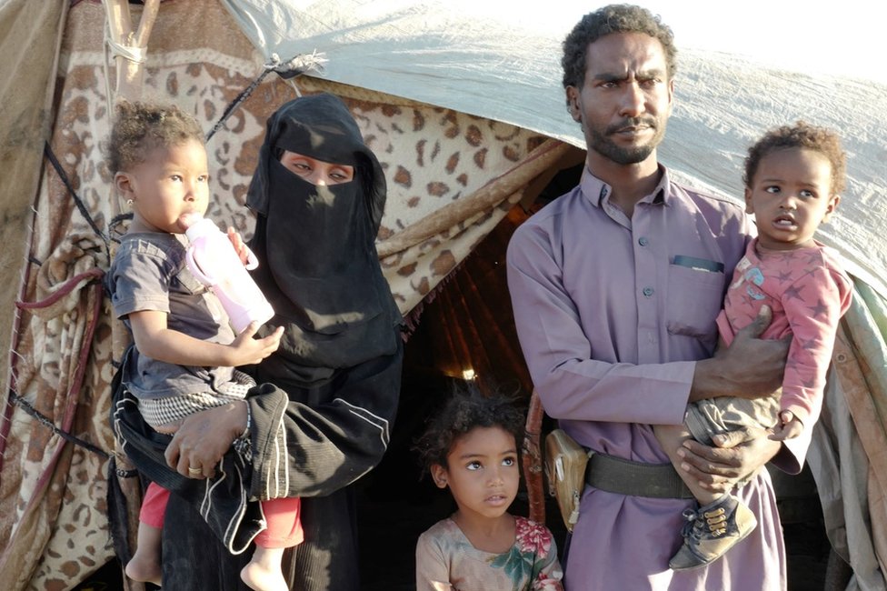 Abdullah (2nd R), Latifah (2nd L) and their family at a camp for displaced people in Marib, Yemen