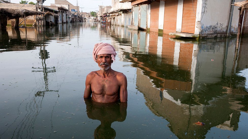 Man in the centre of the town of Khairpur Nathan Shah in Pakistan, which had been totally submerged by floodwaters