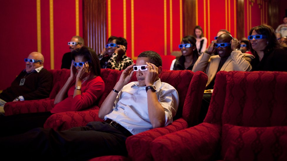 The Obamas wear 3D glasses while watching the Super Bowl in the family theatre of the White House on 2 February 2009