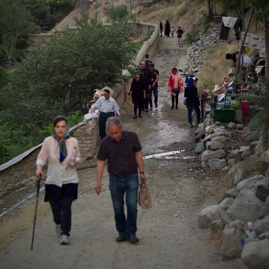 Iranians hike on a trail
