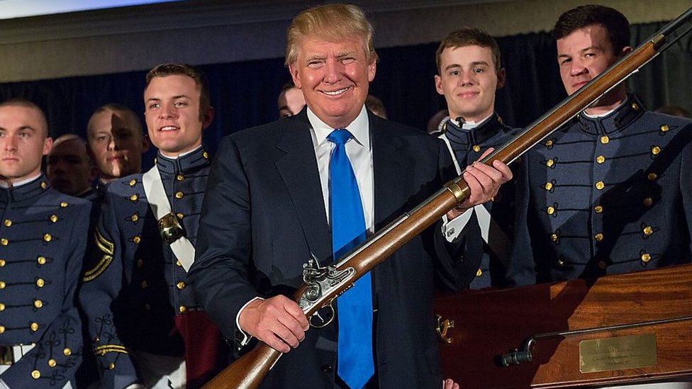 Donald Trump holding a long gun