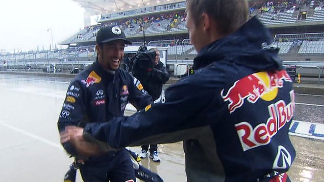 Red Bull's Daniel Ricciardo and Daniil Kvyat dance in the pit lane