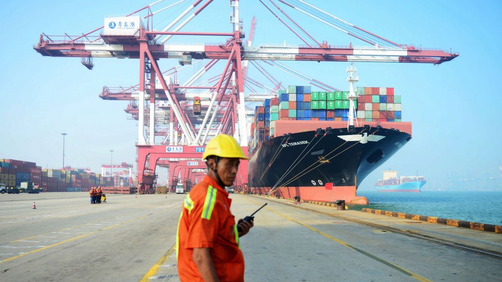 Dock worker in front of ship