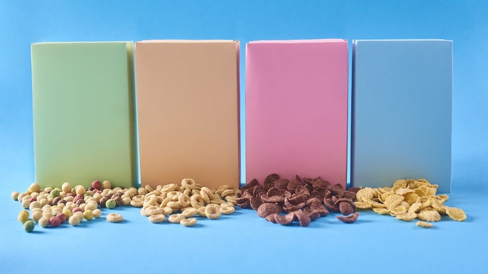 Concept image: generic colourful boxes, with different cereals on the table - blue background