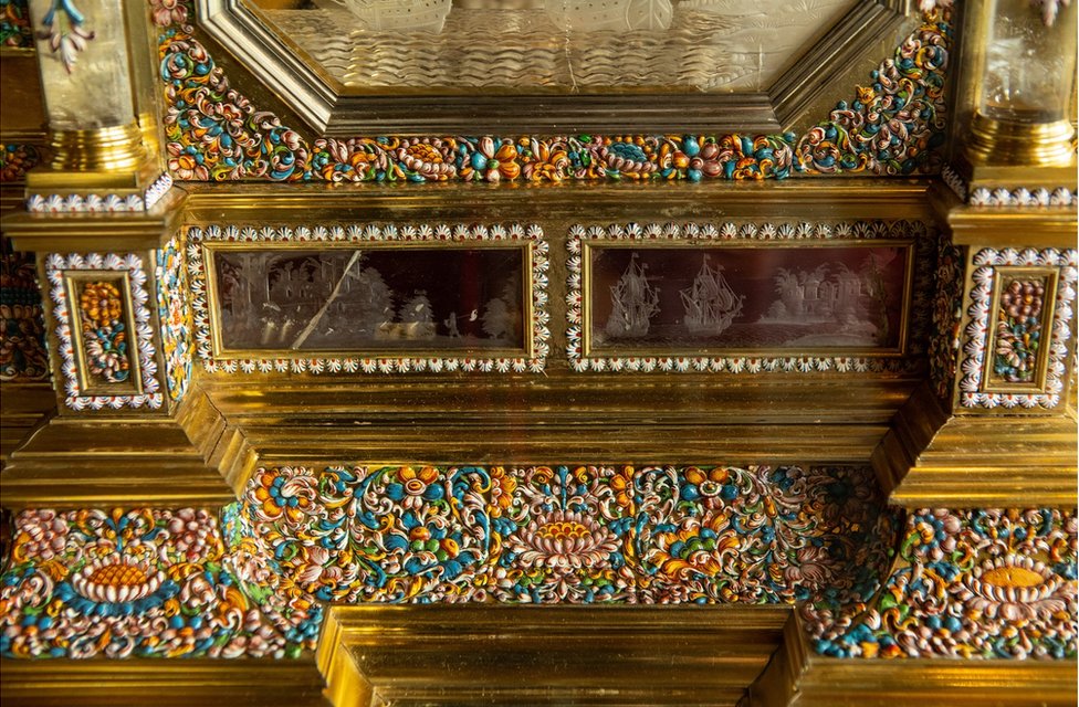 A close up of the decoration of rock crystal and enamel on the casket of an organ clock