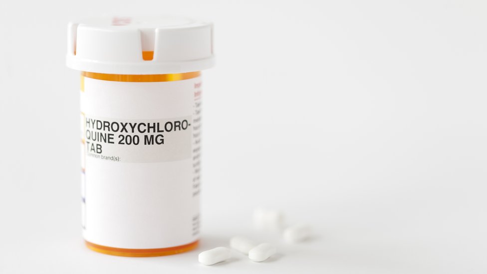 Frasco ao lado de pílulas escrito 'hydroxicholoroquine'