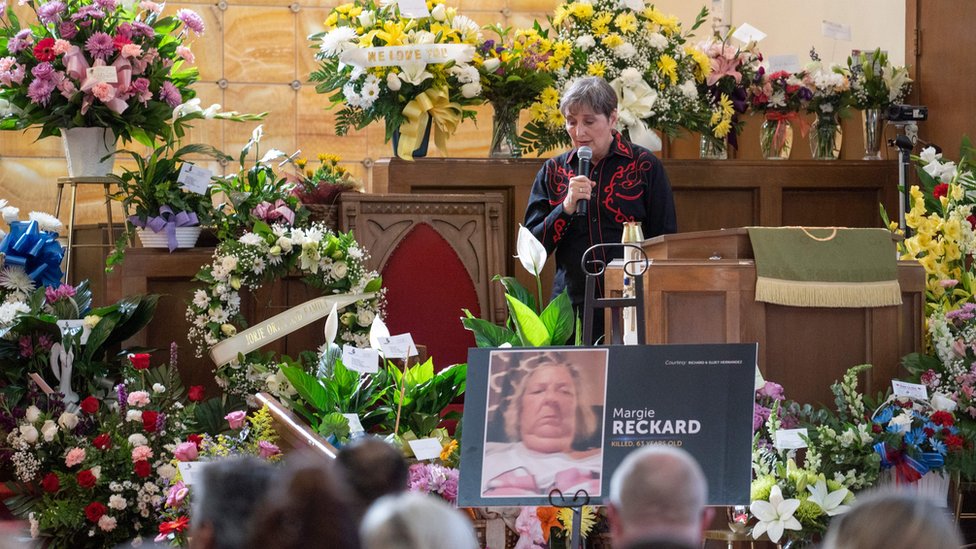 A woman speaks during the funeral of Margie Reckard