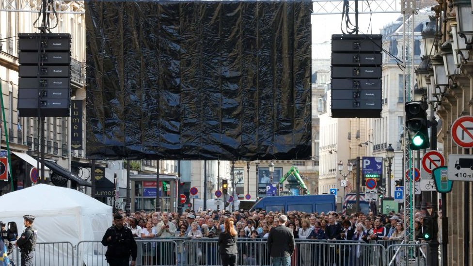 Crowds watch funeral on screen