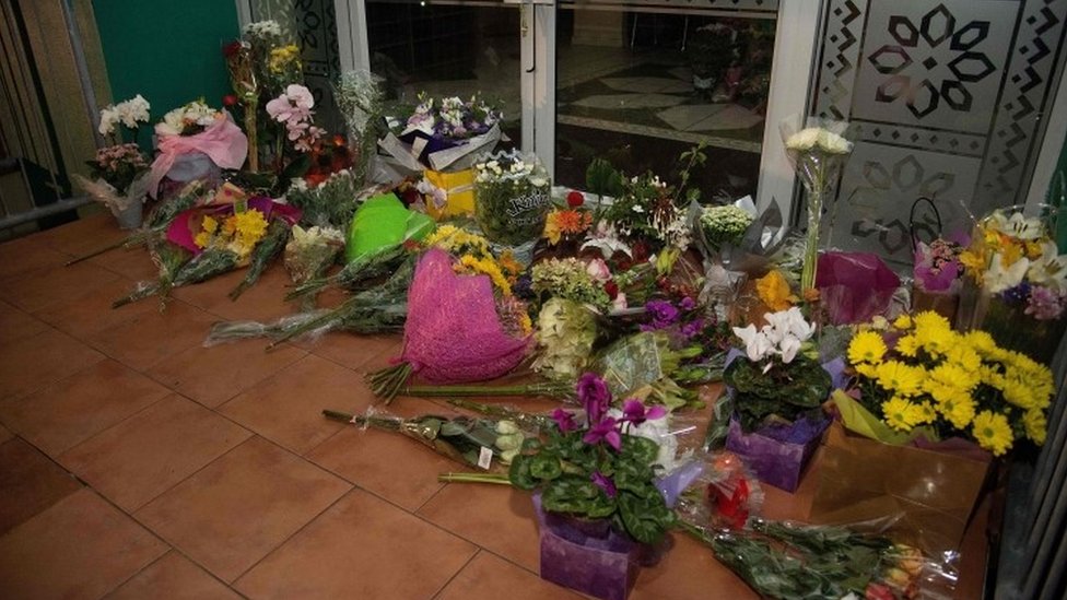 Flowers are placed on the front steps of the Wellington Masjid mosque in Kilbirnie in Wellington on 15 March 2019