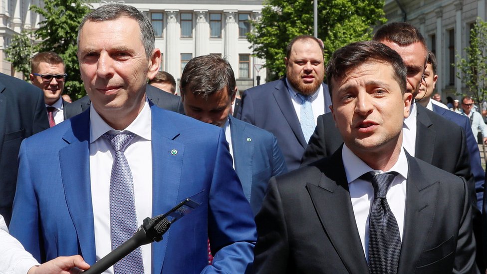 Ukraine's President Volodymyr Zelensky (R) walks from the parliament to the presidential administration office accompanied by his aide Serhiy Shefir