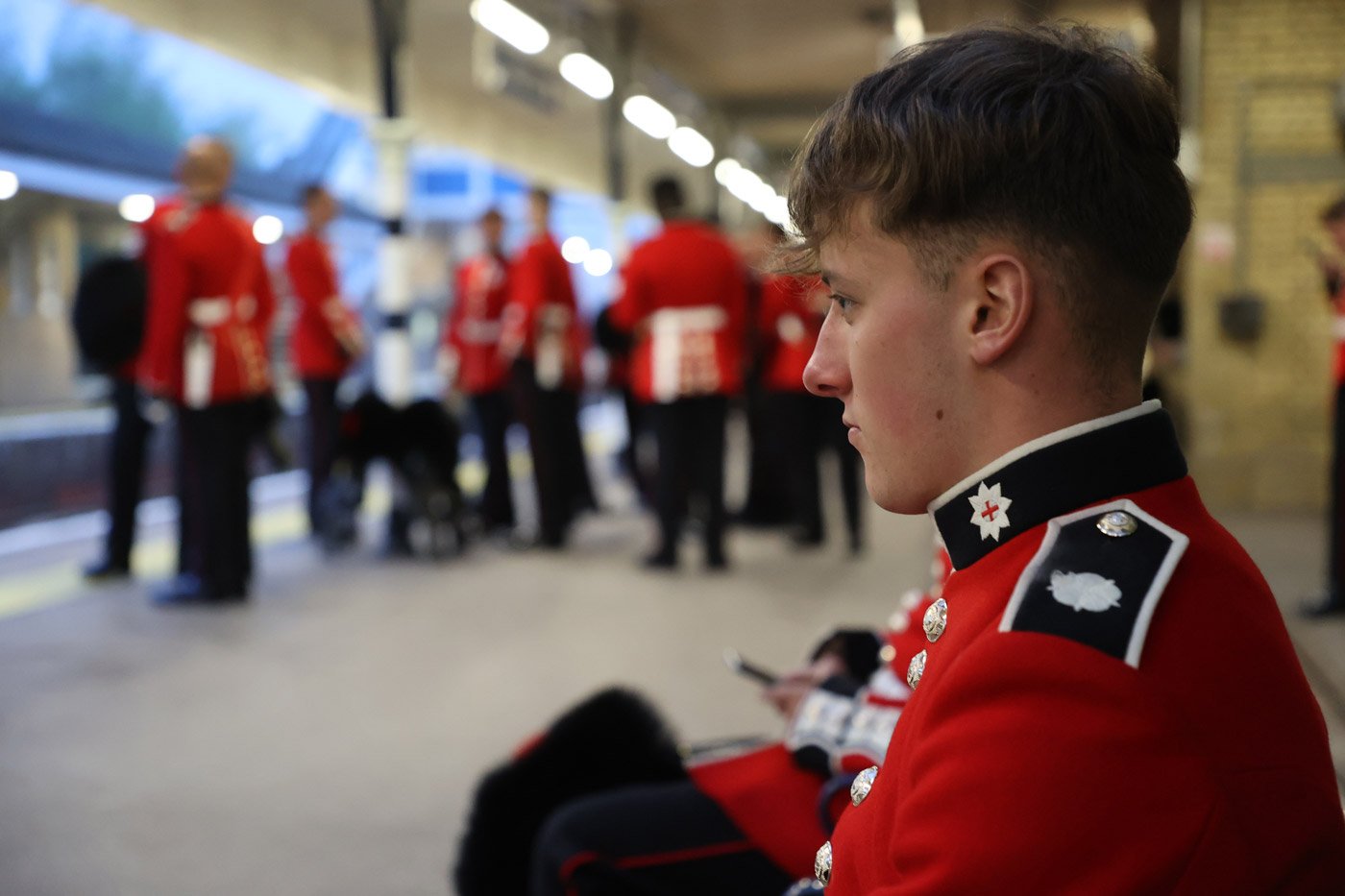 A member of the Armed Forces waits for a train to London Waterloo