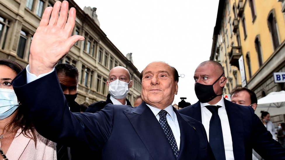 Italy"s former Prime Minister Silvio Berlusconi waves after he voted in Italian elections for mayors and councillors, in Milan, Italy, October 3, 2021