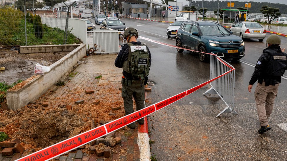 Izraelski policajac pregleda krater koji je ostavila raketa ispaljena iz južnog Libana