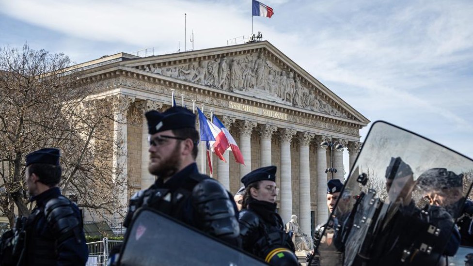 Police officers secure the access to the National Assembly as Labour Unions members demonstrate against the pensions system reform in Paris, France, 16 March 2023.