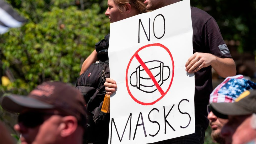 US demonstrators with a banner against the use of face masks