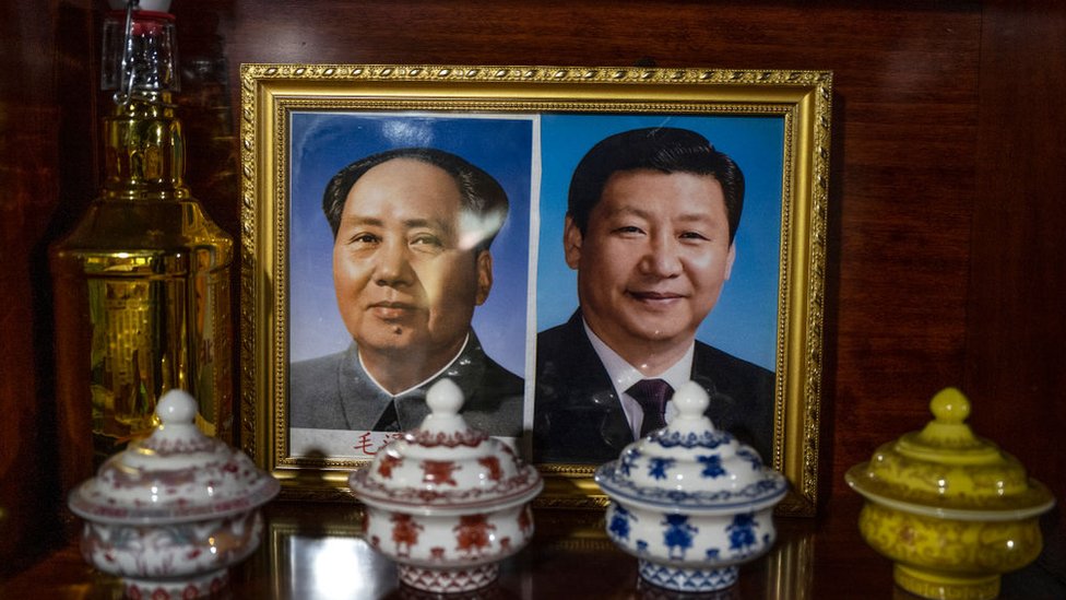 A photo of President Xi Jinping and Chairman Mao Zedong is seen in a Tibetan homestay in the Lulang town tourist village during a government organized visit for journalists on June 4, 2021 in Linzhi, Tibet