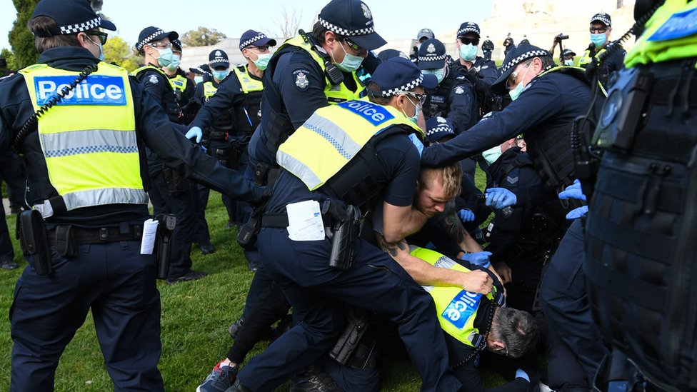 police grapple a protester