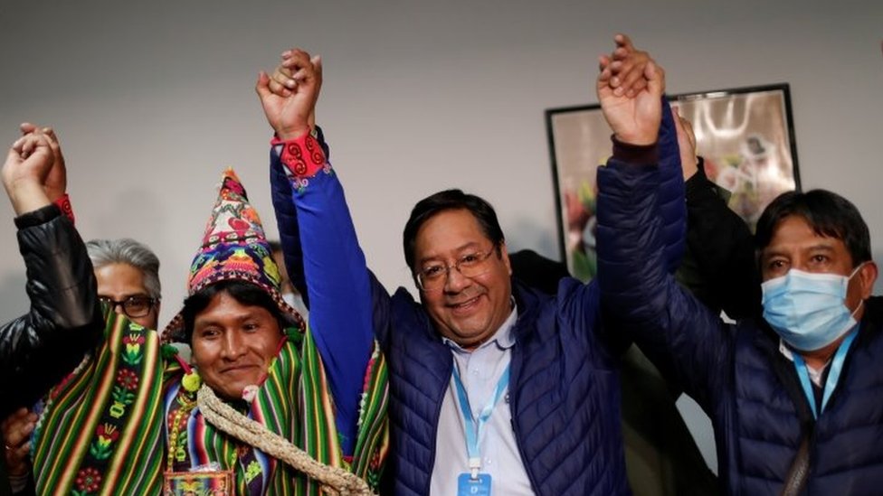 Presidential candidate Luis Arce of the Movement to Socialism party (MAS) reacts next to vice presidential candidate David Choquehuanca, who wears a protective face mask, after addressing the media during the presidential election in La Paz, Bolivia, October 19, 2020.