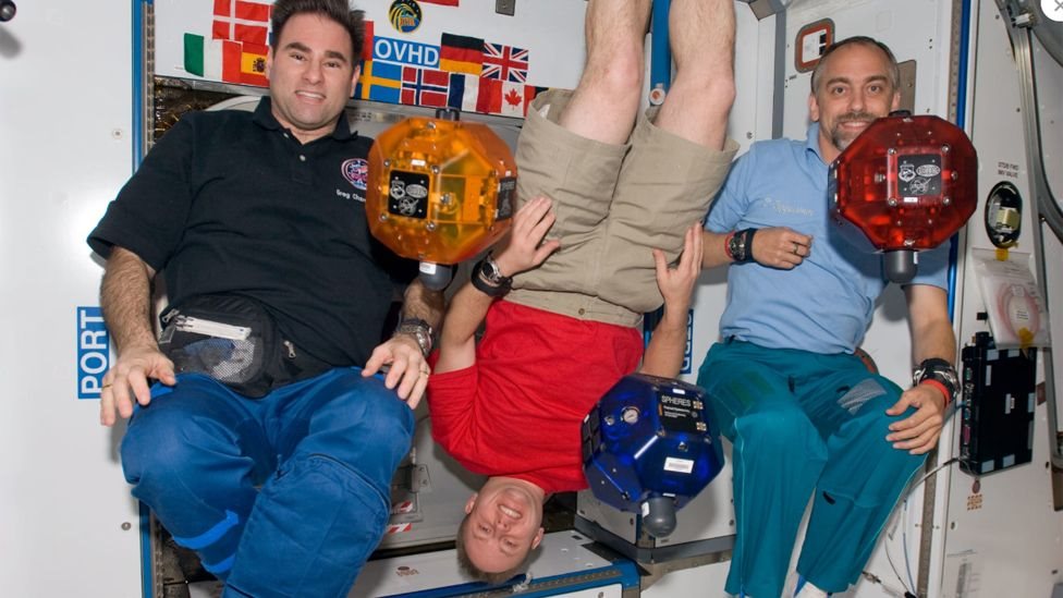 Richard Garriott floating on board the International Space Station with two crewmates