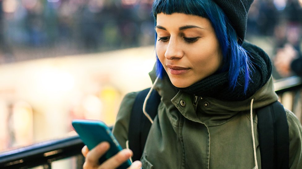 Young woman holding a mobile phone