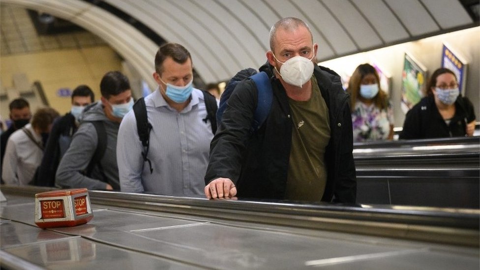 Commuters on the Tube wearing a face covering