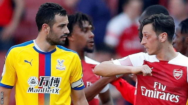 Arsenal's Mesut Ozil and Crystal Palace's Luka Milivojevic talk after Palace's 3-2 win at Emirates Stadium