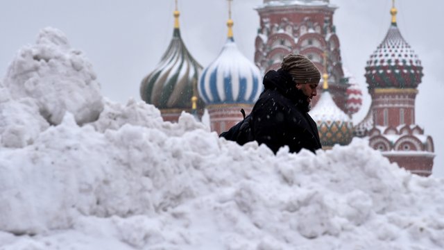 A man walks past Saint Basil's cathedral in central Moscow