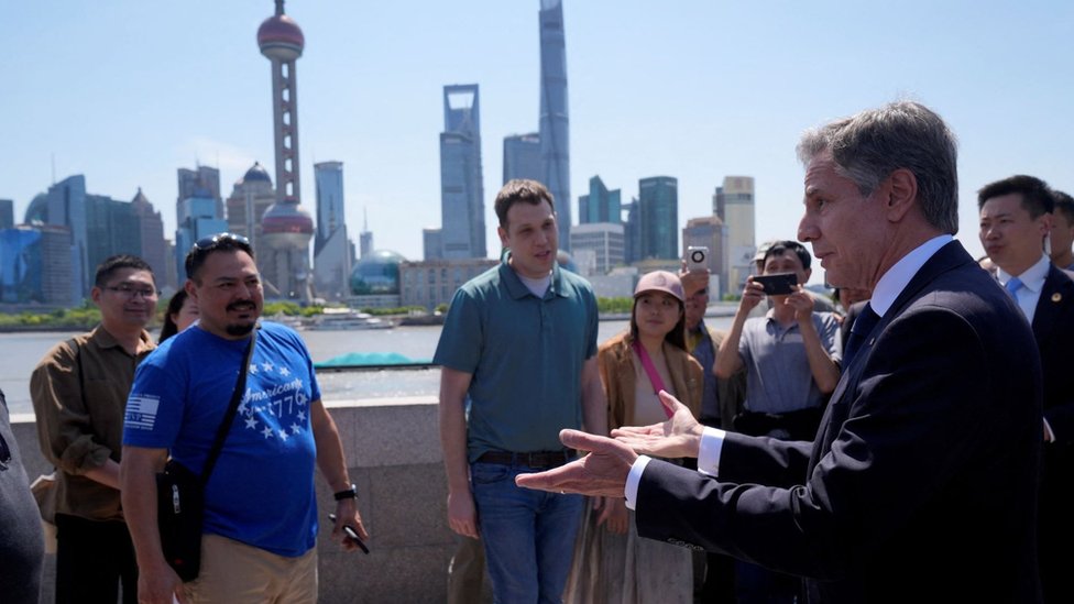 U.S. Secretary of State Antony Blinken speaks with U.S. tourists as he walks in a waterfront area called The Bund, in Shanghai, China April 25,