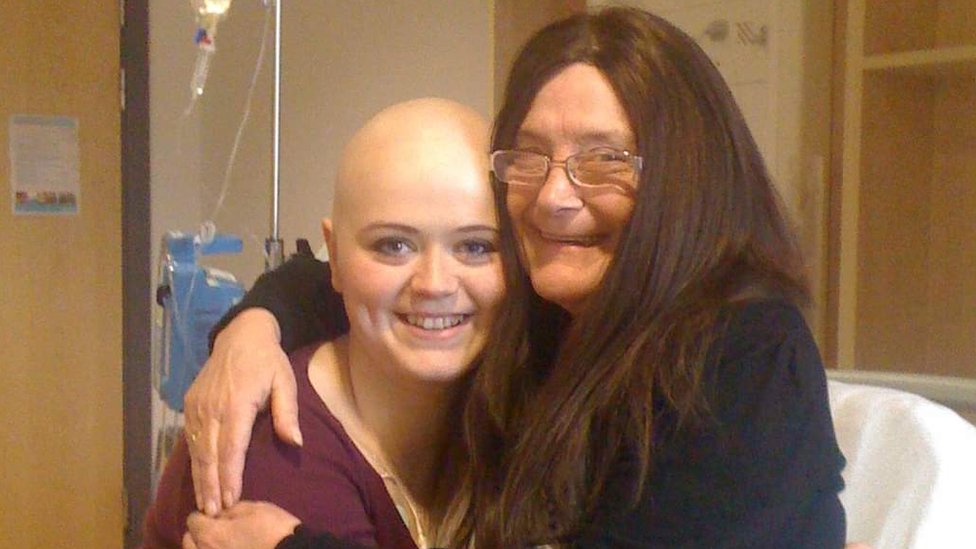 Eimi hugging her grandma on a hospital bed