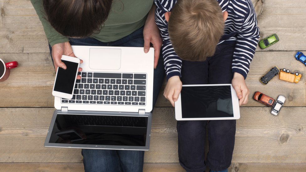 madre y niño usando laptop
