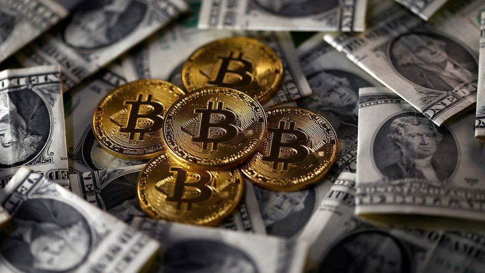 US dollar bills and coins symbolising Bitcoins