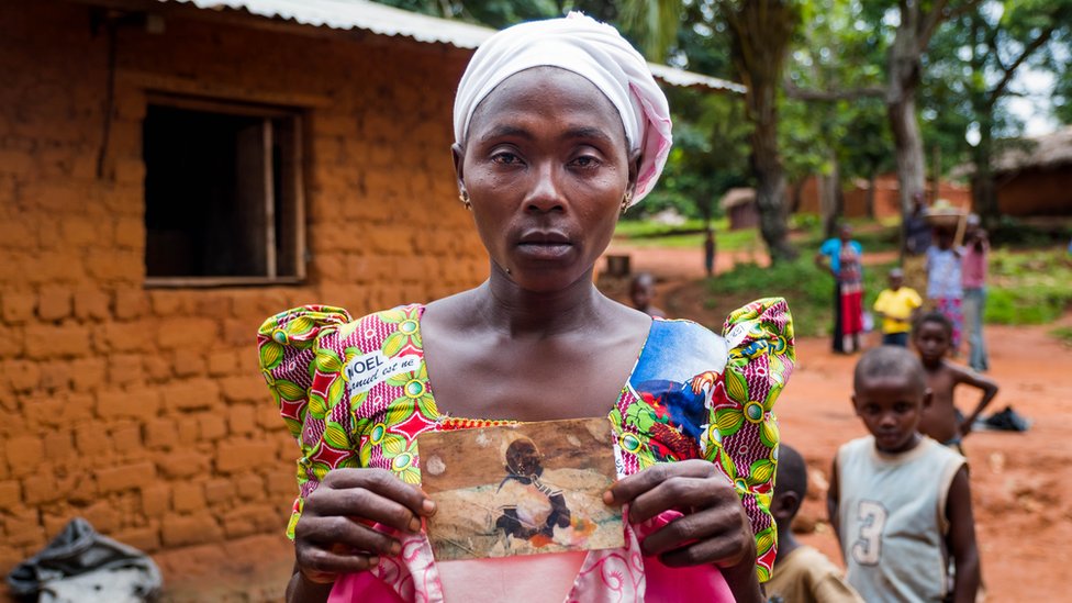Suriya Muyombe holds a picture of her missing child