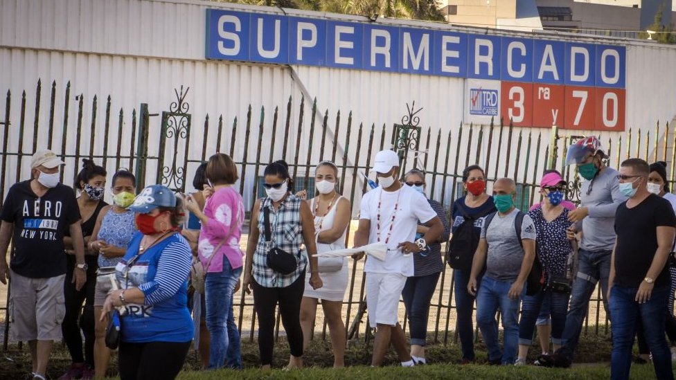 People queuing outside a Cuban supermarket