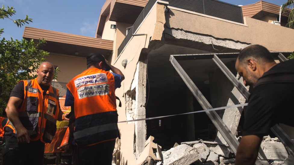 Aşkelon'da Gazze'den atılan bir roketin isabet ettiği evdeki İsrailli kurtarma görevlileri.