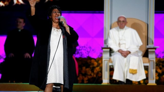 Pope Francis listens as Aretha Franklin performs on stage during the Festival of Families
