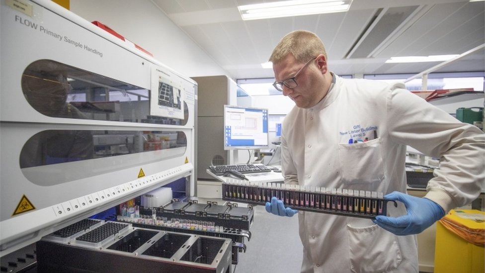 Лаборатория тестирования на коронавирус: Технический специалист по клинической поддержке Дуглас Конди извлекает вирусы из образцов мазков