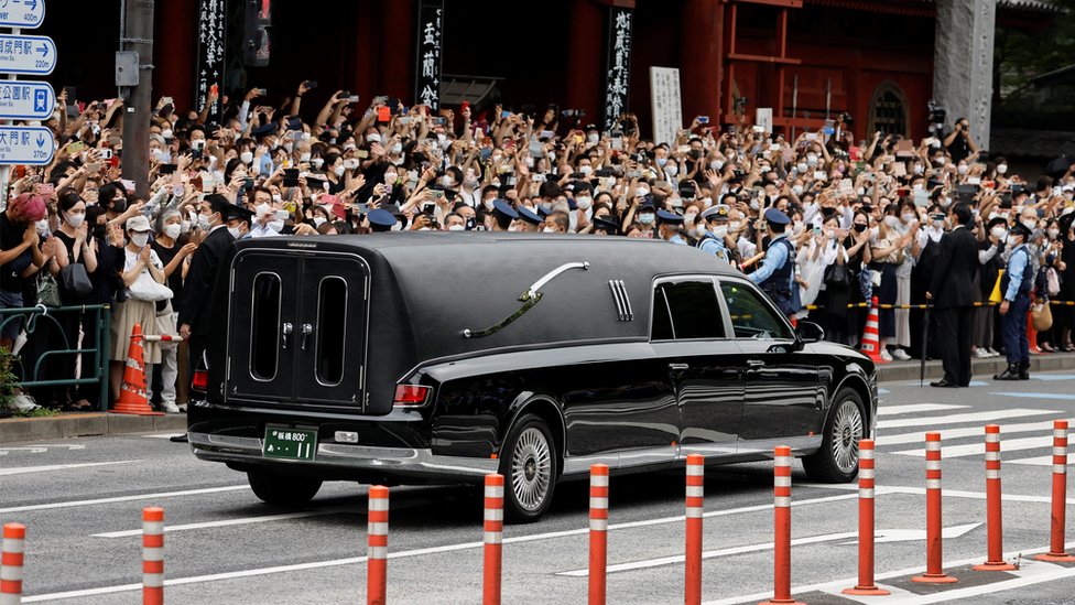 A vehicle carrying the body of the late former Japanese Prime Minister Shinzo Abe, who was shot while campaigning for a parliamentary election, leaves after his funeral at Zojoji Temple in Tokyo, Japan July 12, 2022.