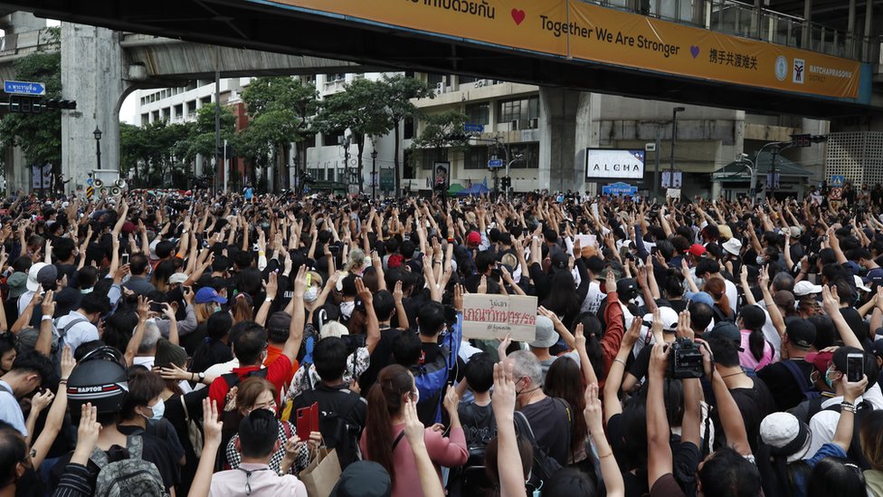 Pro-democracy protesters flash the three-finger salute during a rally against the state of emergency at Ratchaprasong district in Bangkok, Thailand, 15 October 2020.