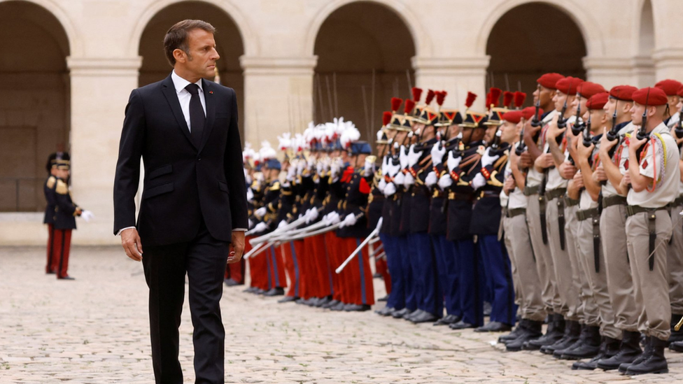 French President Emmanuel Macron reviews troops during a national tribute to late French Army General Jean-Louis Georgelin, former Chief of Staff of the Armed Forces, former Grand Chancellor of the Legion of Honour, in charge of Notre-Dame de Paris Cathedral reconstruction, in the courtyard of the Hotel National des Invalides in Paris, France, 25 August 2023.