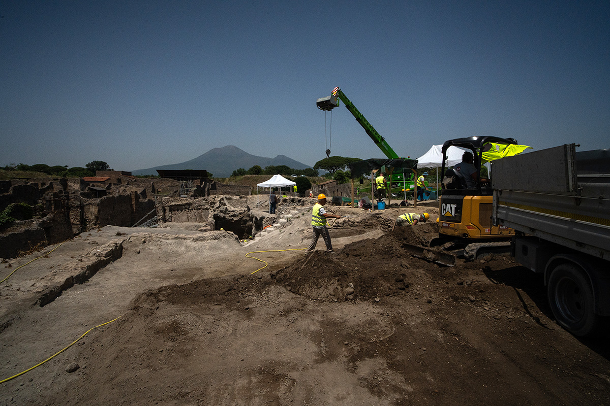 Excavation work underway in the searing summer heat, in the shadow of Mount Vesuvius