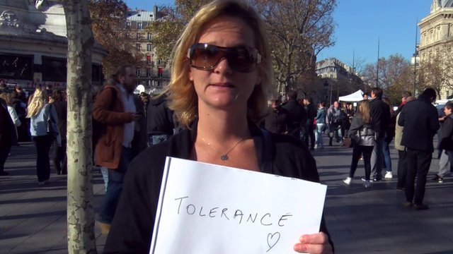 Woman holding pad displaying the word 'tolerance'