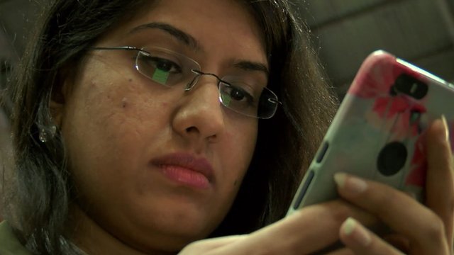 Woman checks smartphone